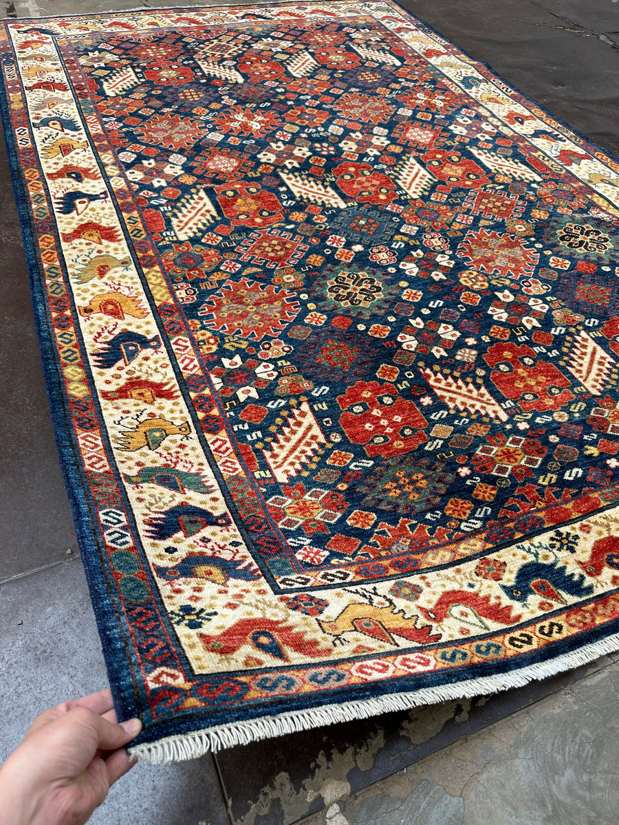 Explore the timeless allure of Rosa Hand-Knotted 9 x 6ft Afghan Mix Rug, an elegant addition to your decor.