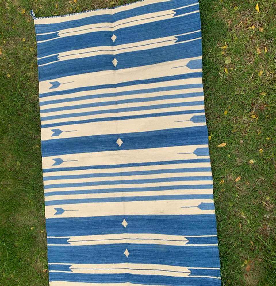 Blue and White Jail Dhurrie Rug color comparison with grass