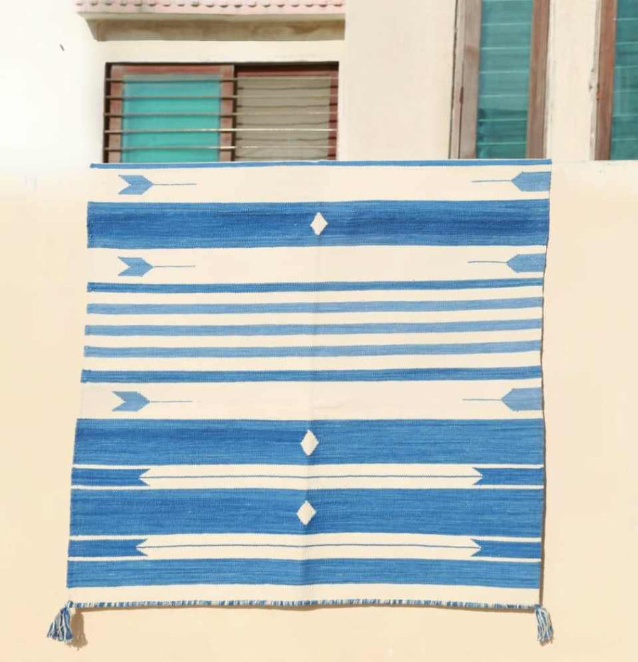 Blue and White Jail Dhurrie Rug hanging outdoors