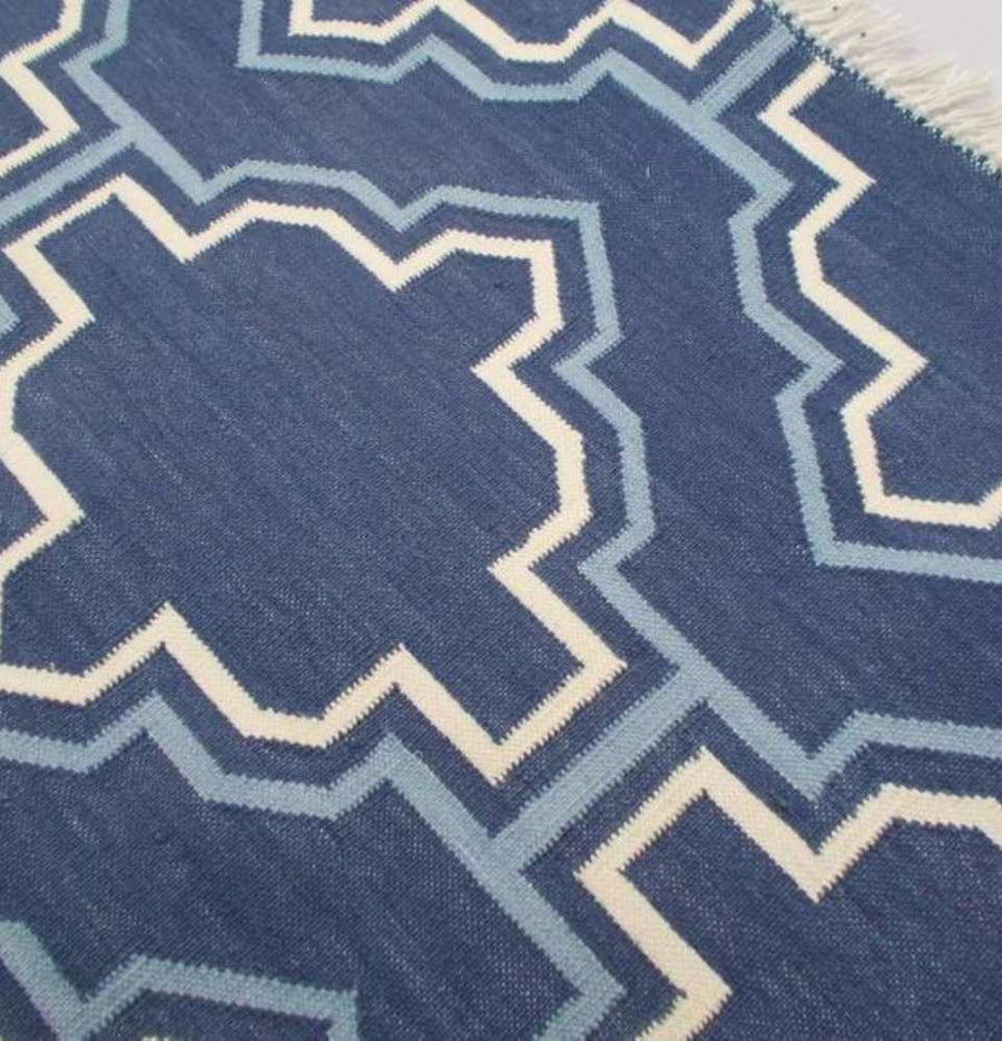 Discover the artistry behind the Denim Blue Casablanca Flatweave Dhurrie Rug, a unique addition to your space.