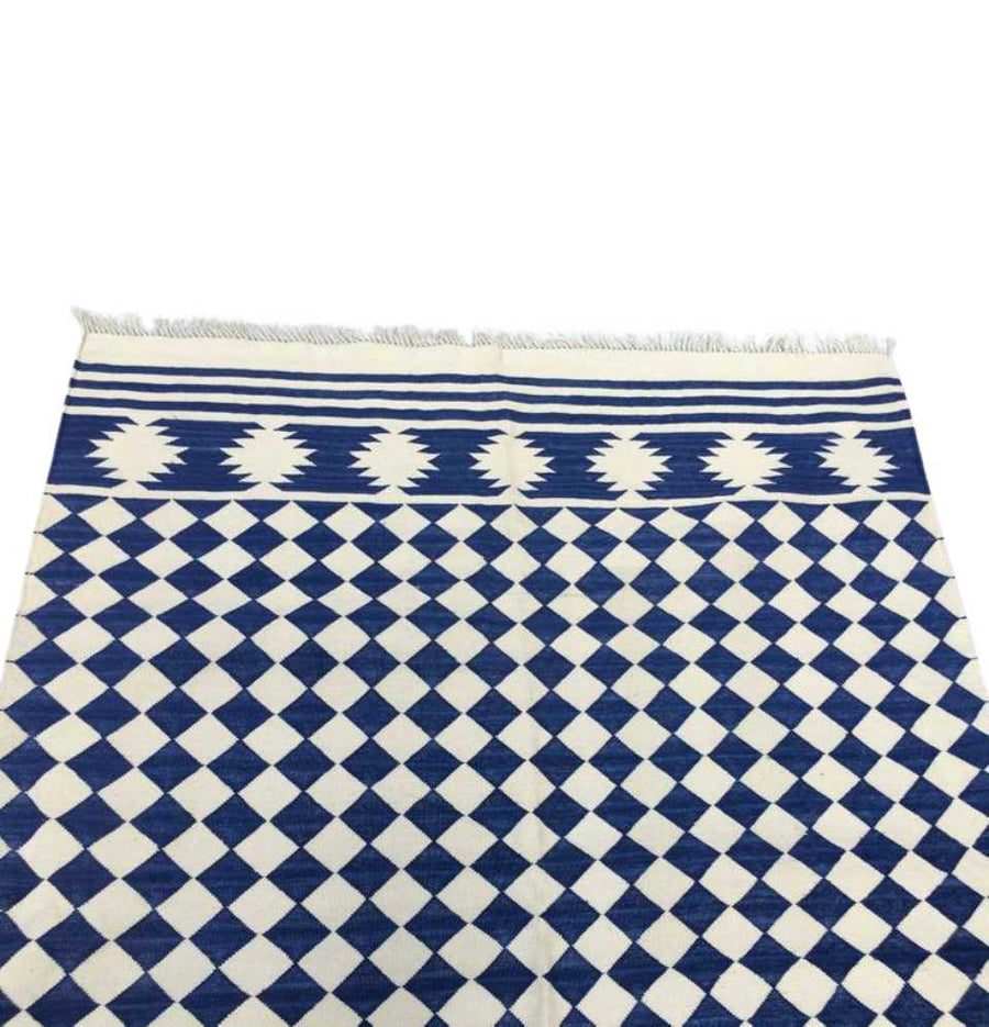 Delve into the precision in the weaving process of Diamond Blue Check Flatweave Dhurrie Rug, a versatile addition to your decor.